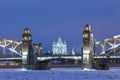 Peter the Great Bridge and Smolny Cathedral in Saint-Petersburg with lights in the winter night Royalty Free Stock Photo