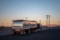 Peterbilt long nose truck with a large trailer driving on the deserted roads