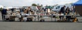 Tables with goods and shoppers at antique fair