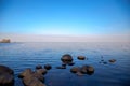 View of the Gulf of Finland horizon with a mansion on a small island in the Peterhof Museum. Spring Sunny day. St. Petersburg, Rus