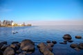 View of the Gulf of Finland horizon with a mansion on a small island in the Peterhof Museum. Spring Sunny day. St. Petersburg, Rus