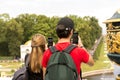 Peterhof, Russia, 08 aug 2019. Tourists take pictures of the attraction. Focus on smartphone Royalty Free Stock Photo