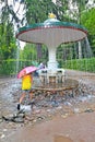 PETERHOF, RUSSIA. The girl runs to the Umbrella fountain cracker in Nizhny park