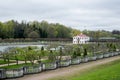 PETERHOF, RUSSIA - MAY 10, 2015: Lower gardens of Park of Peterhof, a view to a pond and a lonely house Royalty Free Stock Photo