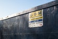 GMB Demolition danger keep out sign on a large blue solid fence wall with blue sky behind Royalty Free Stock Photo