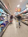 Shoppers with trolley carts wearing face masks in chiller asile of Aldi supermarket Royalty Free Stock Photo