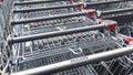 Row of Aldi supermarket trolleys showing company branding on handles