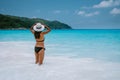 Petite Anse Mahe Seychelles, young woman on the beach, mid age Asian woman walking on tropical beach Seychelles