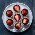 Petite desserts featuring strawberries and chocolate, served on white plate