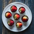 Petite desserts featuring strawberries and chocolate, served on white plate