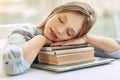 Petite teenage girl taking nap on books Royalty Free Stock Photo