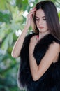Petite young woman wear only her lamb fur vest