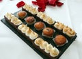 Delicious petits fours with meringue and chocolate tart