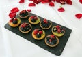 Petits fours with raspberries, blackberries, kiwi, forest berries for the bridal couple and wedding guests