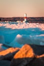 Petoskey, MI /USA - March 3rd 2018: Shot of a tourist climbing along the frozen over pier to a light house in Petoskey Michigan