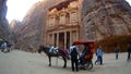 Tourists view the Al-Khazneh ancient city of Petra in Jordan Royalty Free Stock Photo