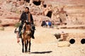 Arab bedouin guide riding in the ancient city of Petra, Jordan Royalty Free Stock Photo