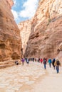 Tourists between rocks in the ancient city of Petra, Jordan. Petra is a historical and