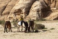 Image of a local bedouin boy and four horses near petra