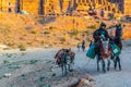 PETRA, JORDAN, JANUARY 2, 2019: bedouin riding a donkey in front of the urn tomb in petra, Jordan