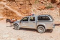 PETRA, JORDAN - MARCH 24, 2017: Donkey and a Tourism Police car in the ancient city Petra, Jord