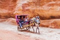 PETRA, JORDAN - MARCH 23, 2017: Horse carriage in the Siq narrow gorge, main entrance to the ancient city Petra , Jord