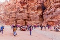 PETRA, JORDAN - MARCH 23, 2017: Tourists, camels and horse carriages in the ancient city Petra, Jord