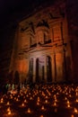 PETRA, JORDAN - MARCH 22, 2017: Tourists observe the Al Khazneh temple (The Treasury) during Petra by Night in the ancient city Royalty Free Stock Photo