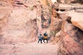 Petra, Jordan - 7th october, 2022: bedouin master with donkey take overweight Petra male visitor client downstairs from little