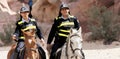 Petra, Wadi Musa, Jordan, March 9. 2018: Two policemen on horseback with funny pimple hoods and signal vests to protect the many i