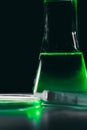 Petri dishand retort with green and blue with a chemical reagent. Chemical experiment with Laboratory glass Royalty Free Stock Photo