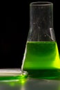 Petri dishand retort with green and blue with chemical reagent. Chemical experiment with Laboratory glass Royalty Free Stock Photo