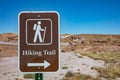 Metal brown sign with a white color walker informs the visitors that this area has a hiking trail. Petrified Forest, Arizona, US Royalty Free Stock Photo