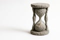 Petrified hourglass on a light background. Space for text. Royalty Free Stock Photo
