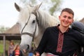 Petrikovka, Dnepropetrovsk region, Ukraine, 28 04 2019 A young Ukrainian man, Cossack in embroidered shirt smiles and