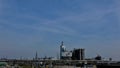 Petrochemical industrial complex under a blue sky at noon.