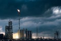 Petrochemical plant and fire on flare stack while burning toxic  oil and gas with cloudy Royalty Free Stock Photo