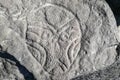 petroglyph carved in stone with the image of a shaman