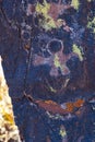 A petroglyph is an image created of an astronaut by removing part of the surface of a rock by incising, chipping, carving a form