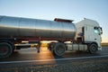 Petrol cargo truck driving on highway hauling oil products. Delivery transportation and logistics concept