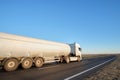 Petrol cargo truck driving on highway hauling oil products. Delivery transportation and logistics concept Royalty Free Stock Photo