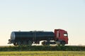 Petrol cargo truck driving on highway hauling oil products. Delivery transportation and logistics concept Royalty Free Stock Photo