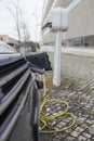 Petrol-electric hybrid car charging at urban charging station