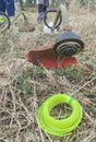 Petrol-powered string trimmer with string roll at forefront Royalty Free Stock Photo
