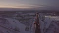 Petrol tanker with flashers standing on roadside on winter highway aerial view