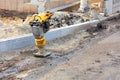 Petrol vibratory rammer is located at the workplace of the construction site