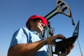 Petroleum Engineer Using Laptop in an Oil Field