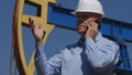 Petroleum Engineer Working in Extracting Oil Industry Talk to Mobile Gesturing