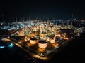 Petroleum oil refinery in industrial estate at night, drone aerial view. Fuel and power generation, petrochemical factory industry Royalty Free Stock Photo