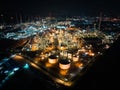 Petroleum oil refinery in industrial estate at night, drone aerial view. Fuel and power generation, petrochemical factory industry Royalty Free Stock Photo